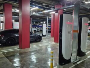 Postes Supercharger de Tesla en el parqueadero del Centro Comercial Unicentro de Medellín, con vehículos conectados